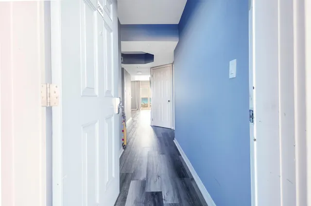 a view of a hallway with wooden floor