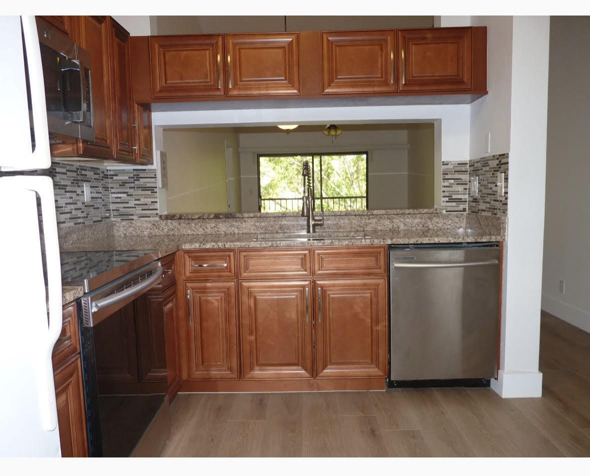 3130 Millwood Terrace, Unit 2120 Boca Raton, FL 33431 - Photo 5 of 15 a kitchen with stainless steel appliances granite countertop a refrigerator and cabinets
