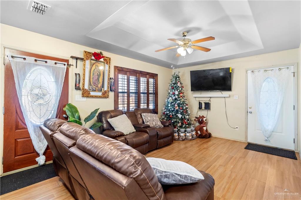 504 West Mahala Avenue Mission, TX 78573 - Photo 4 of 24 a living room with furniture a flat screen tv and a window