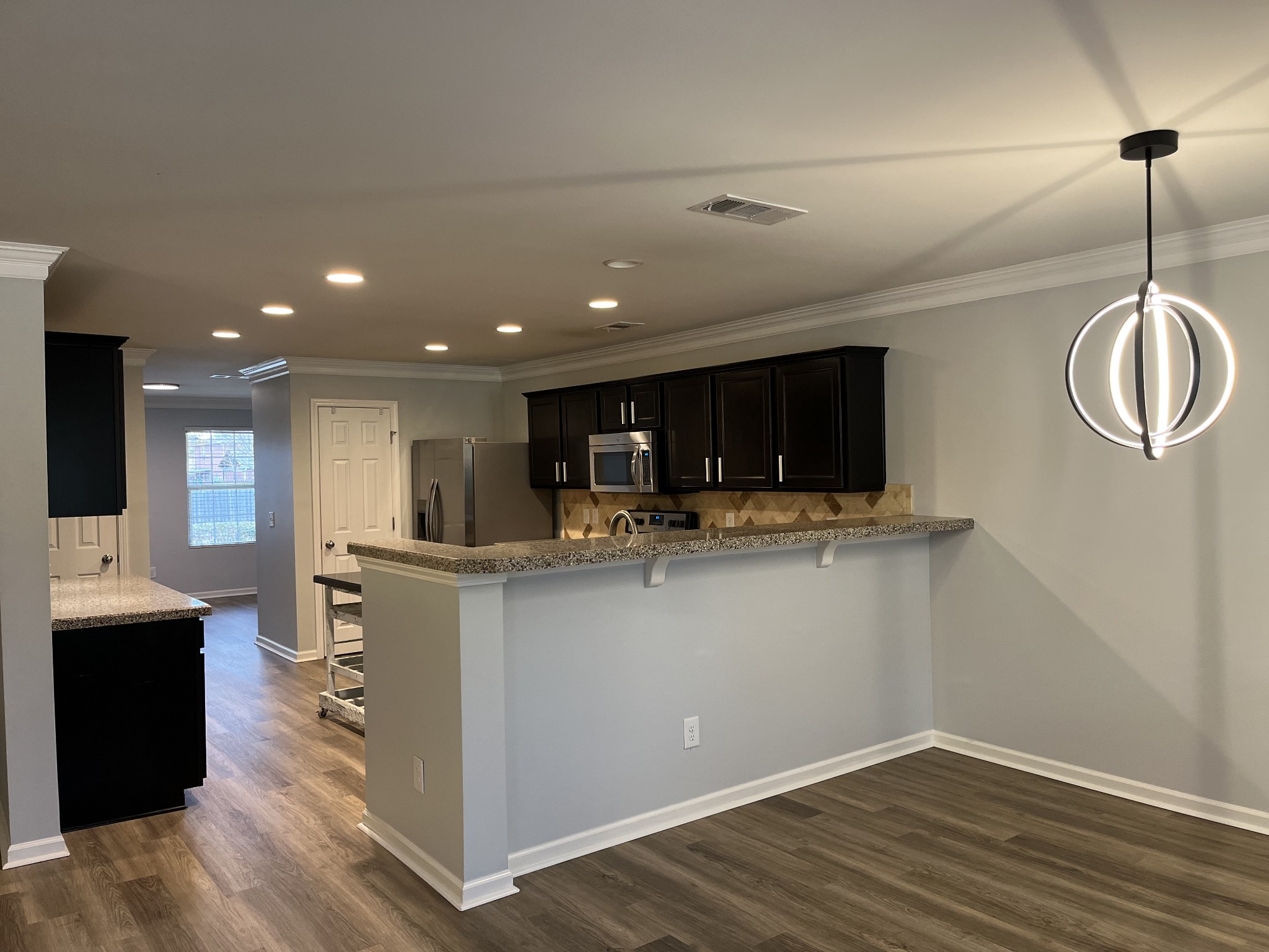 1005 Benwick Road Hendersonville, TN 37075 - Photo 3 of 12 a kitchen with stainless steel appliances granite countertop a sink a stove and a wooden floors