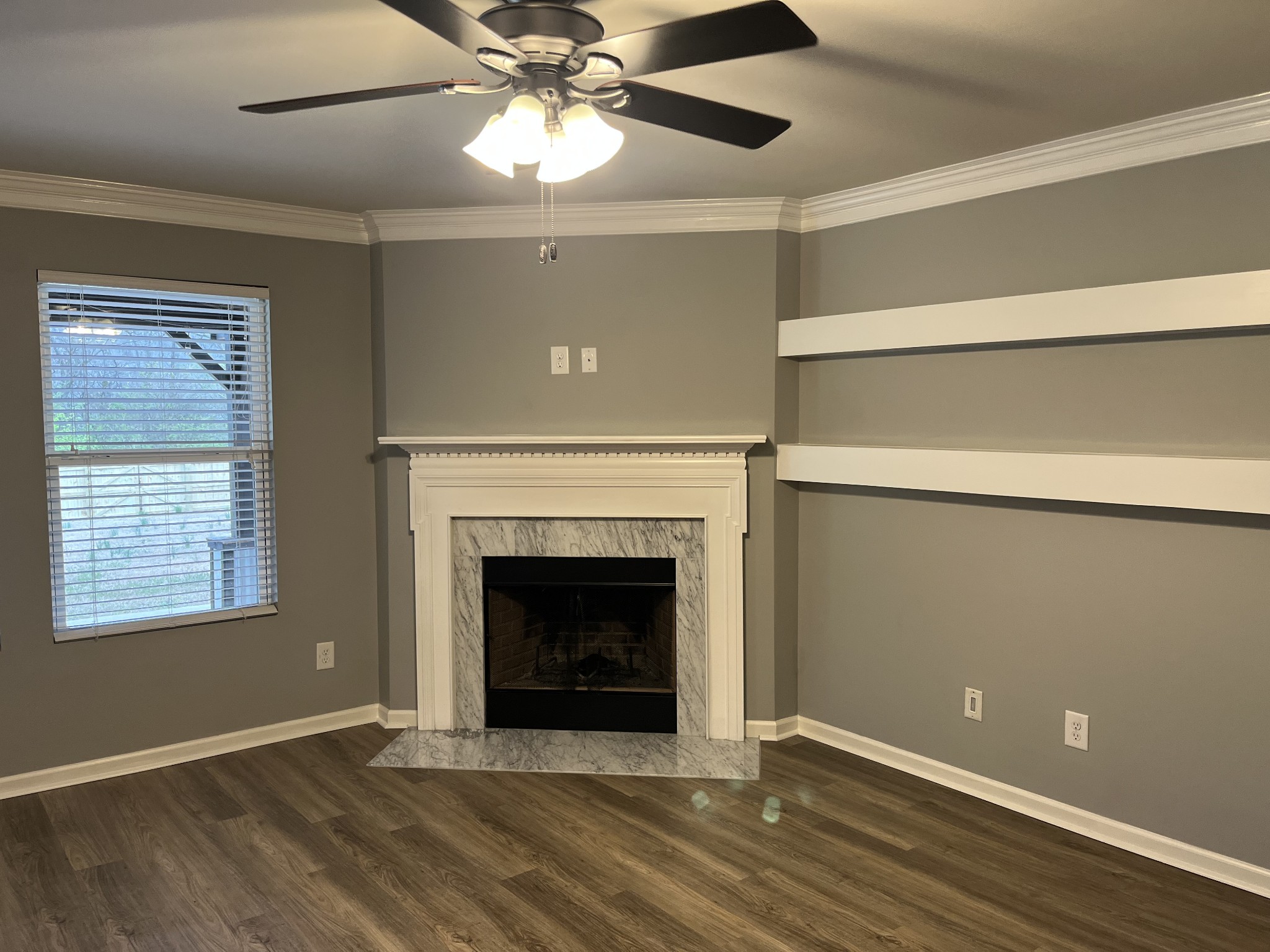 1005 Benwick Road Hendersonville, TN 37075 - Photo 4 of 12 a view of an empty room with wooden floor fireplace and a window