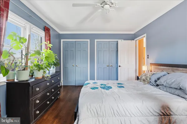 a bedroom with a bed and a potted plant