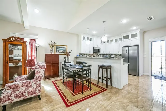 a living room with furniture and kitchen view