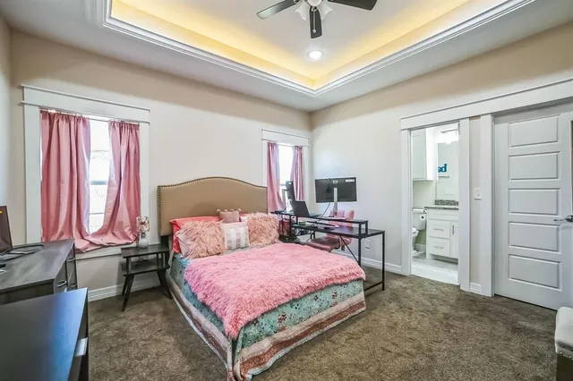 a bedroom with a bed closet and a flat tv screen