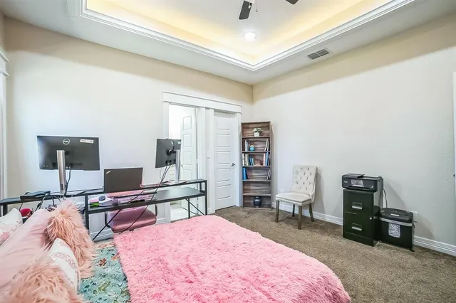 a bedroom with a bed and a desk
