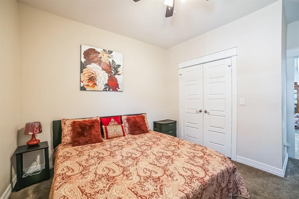 1207 South Lenox Street Tyler, TX 75701 - Photo 21 of 27 a bedroom with a bed and a painting on the wall