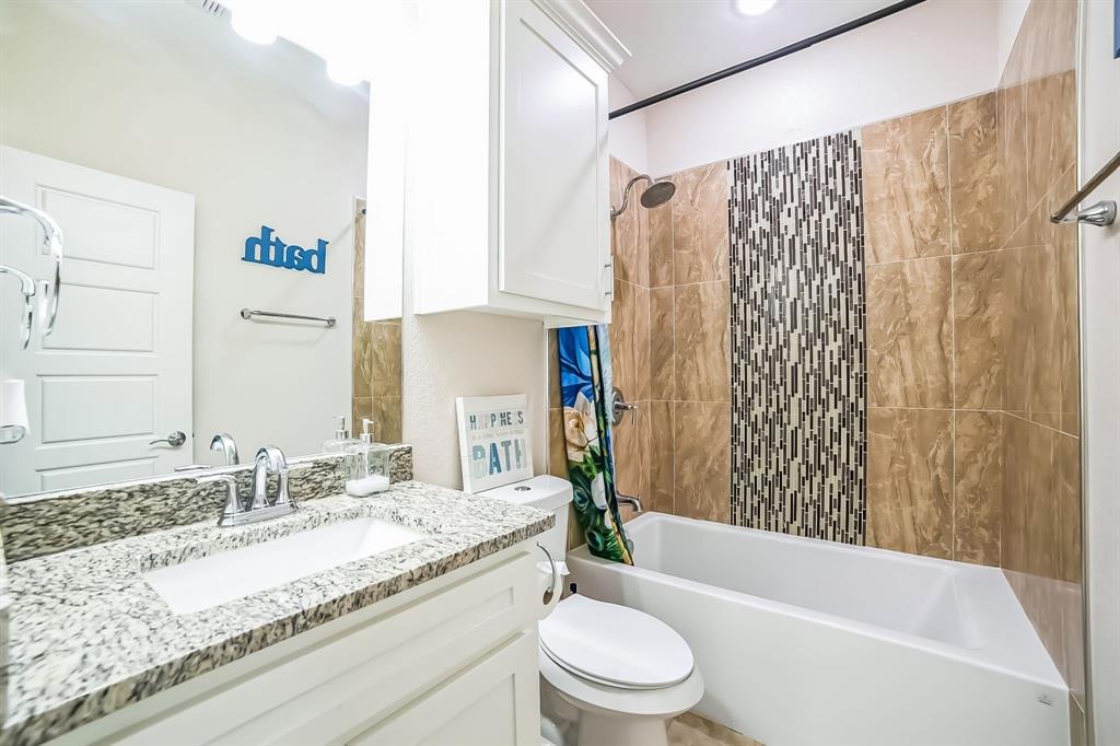 1207 South Lenox Street Tyler, TX 75701 - Photo 22 of 27 a bathroom with a granite countertop bathtub sink vanity mirror and toilet