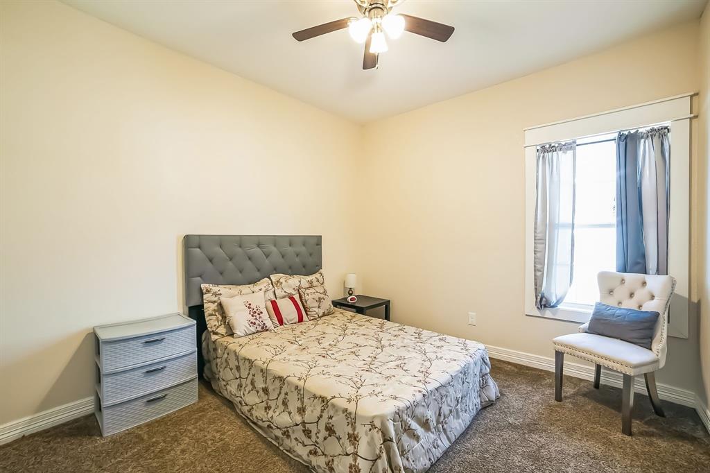 1207 South Lenox Street Tyler, TX 75701 - Photo 23 of 27 a bedroom with a bed and a chair