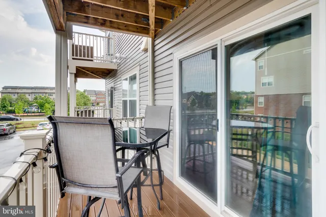a view of balcony with table and chairs