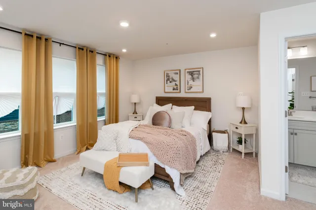 a bedroom with bed and a flat tv screen on dresser