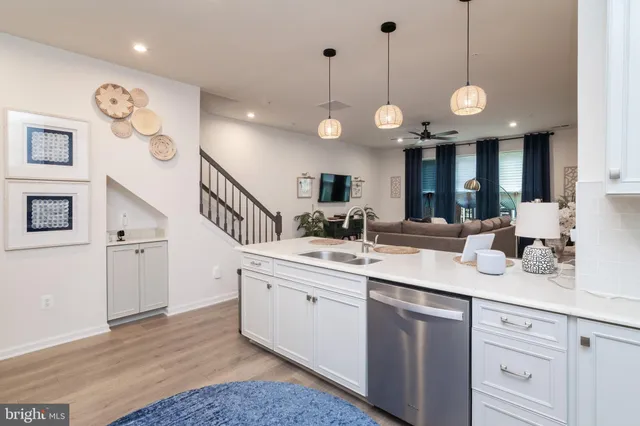 a large kitchen with a large island oven a sink a stove and a wooden floors