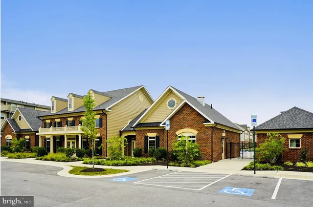 a living room with fireplace furniture and a large window