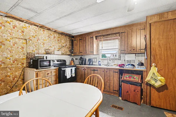 a kitchen with stainless steel appliances a stove a sink dishwasher and wooden cabinets