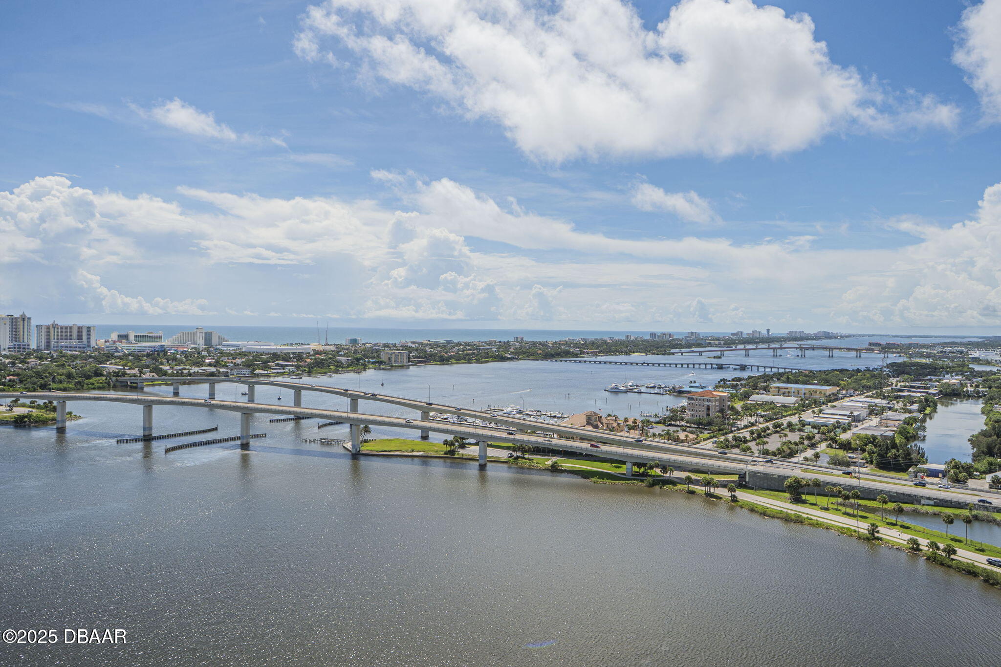 231 Riverside Drive, Unit 2409 Holly Hill, FL 32117 - Photo 2 of 24 an aerial view of a city with lots of residential buildings and lake view