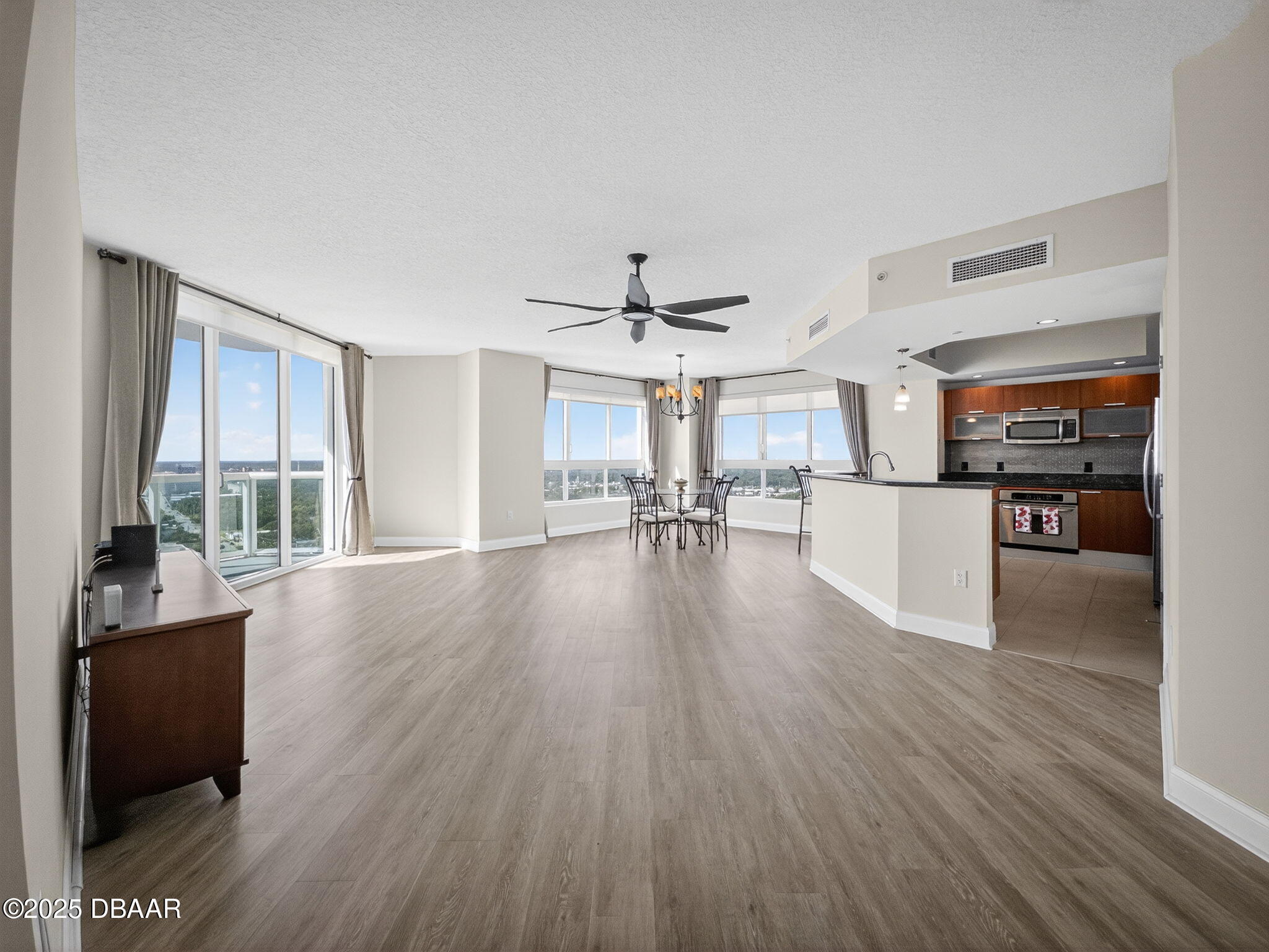 231 Riverside Drive, Unit 2409 Holly Hill, FL 32117 - Photo 3 of 24 a view of a living room hardwood floor and a kitchen