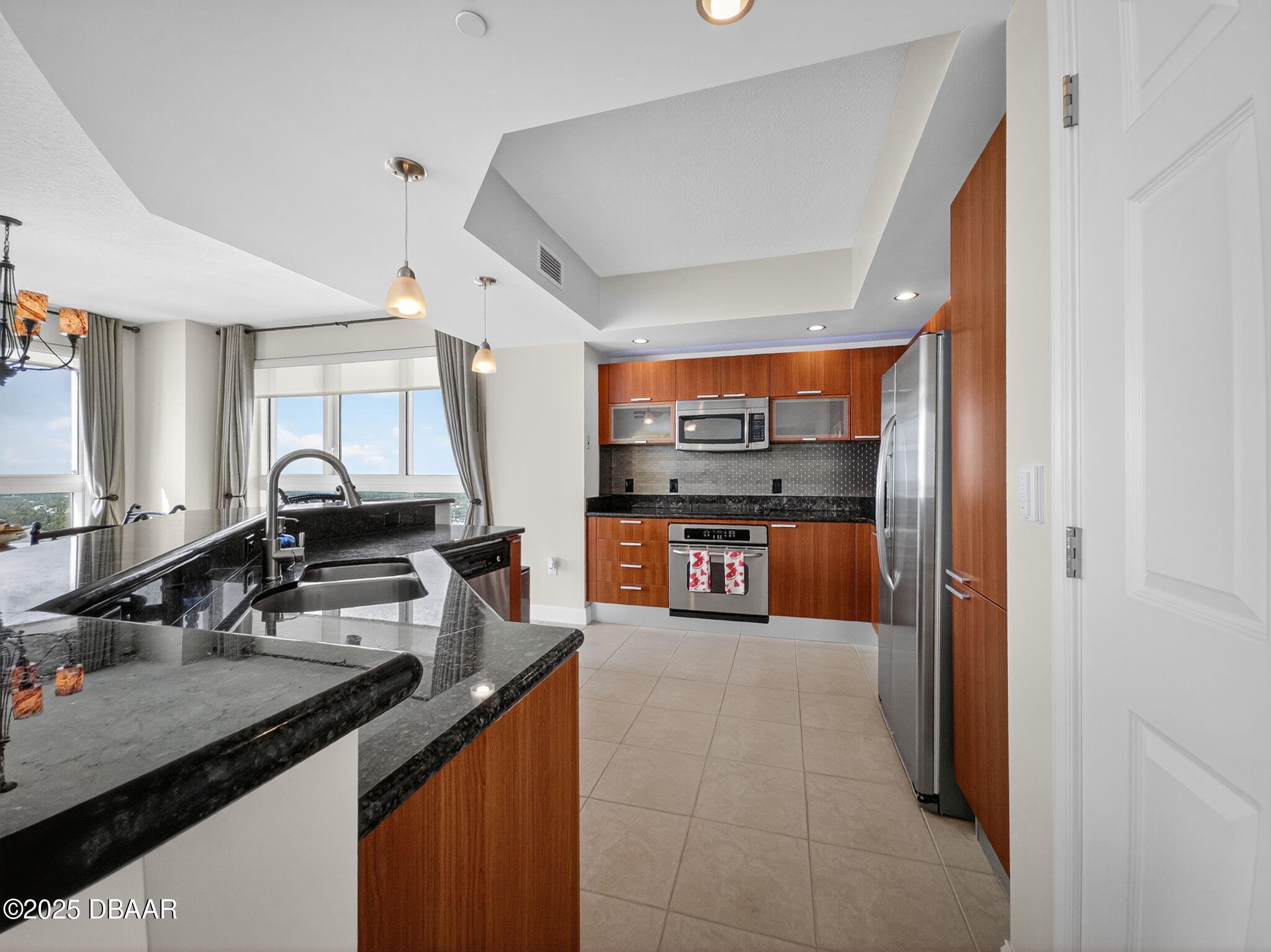 231 Riverside Drive, Unit 2409 Holly Hill, FL 32117 - Photo 9 of 24 a kitchen with stainless steel appliances granite countertop a sink and cabinets