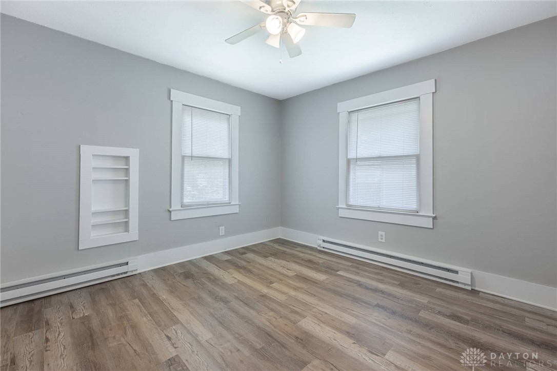 2118 Hillside Avenue Springfield, OH 45503 - Photo 6 of 28 This bright room features a ceiling fan, durable flooring, and ample natural light through multiple windows.