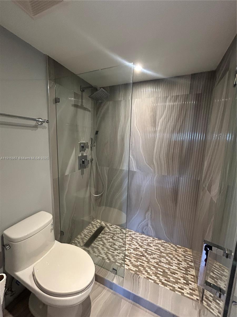 200 Diplomat Parkway, Unit 721 Hallandale Beach, FL 33009 - Photo 13 of 47 a bathroom with a toilet and a shower