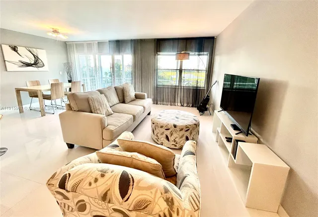 a living room with fireplace furniture and a rug