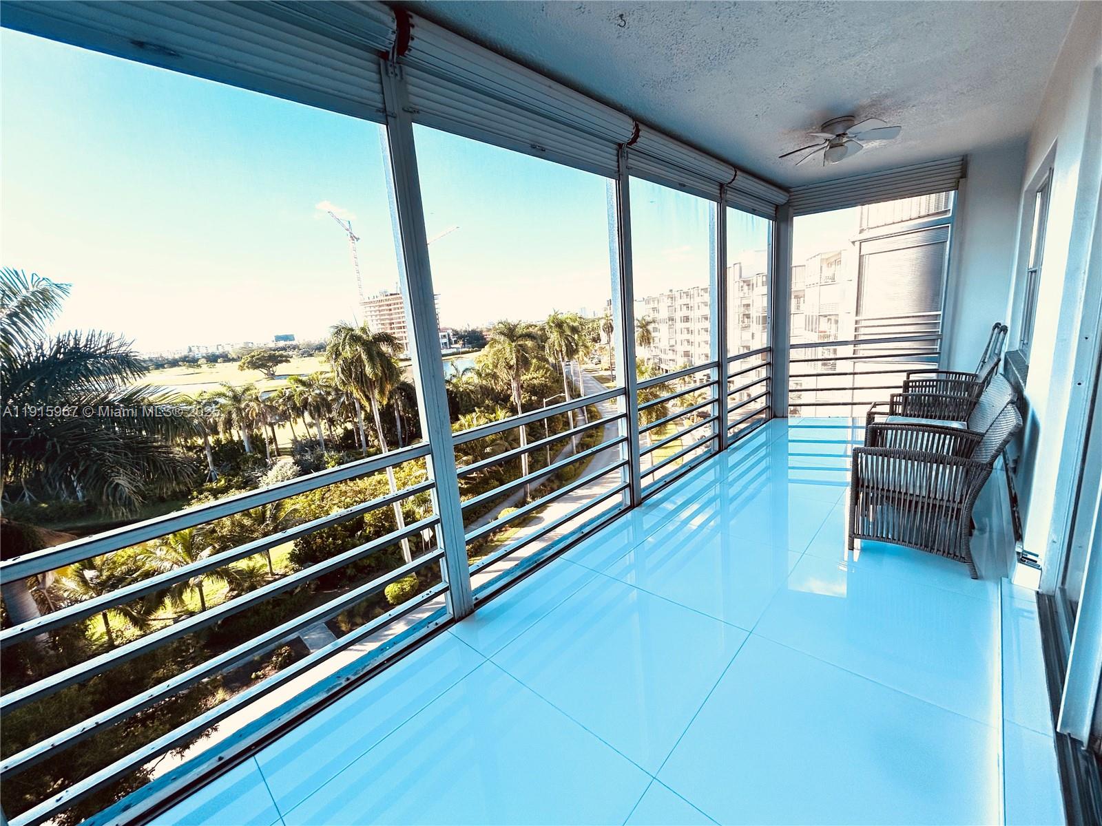 200 Diplomat Parkway, Unit 721 Hallandale Beach, FL 33009 - Photo 29 of 47 a view of a balcony with couch and wooden floor