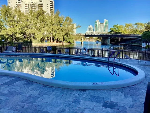 a view of a lake with couches chairs
