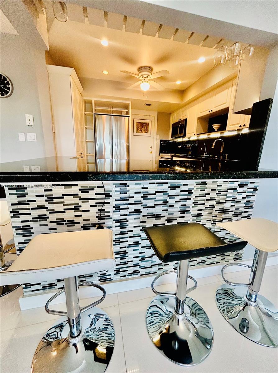 200 Diplomat Parkway, Unit 721 Hallandale Beach, FL 33009 - Photo 5 of 47 a bathroom with a sink and a mirror