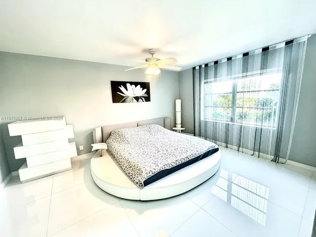 a bathroom with a granite countertop toilet sink and mirror
