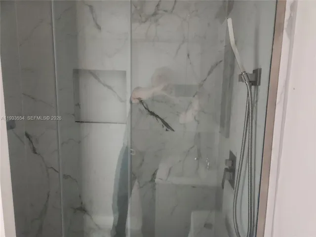 an empty room with a window and a ceiling fan