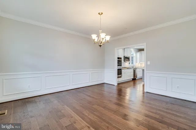 a view of a kitchen with wooden floor and a window