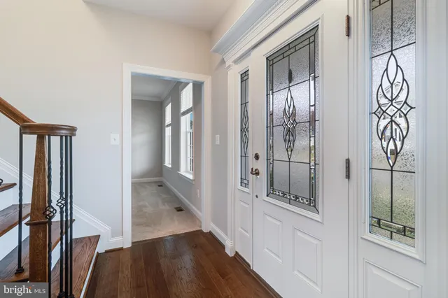 a bathroom with a walk in closet and wooden floor