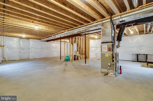 a kitchen with kitchen island granite countertop a stove a sink a center island and wooden floor