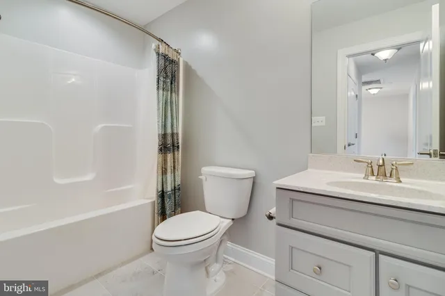 a bathroom with a granite countertop sink mirror and bathtub