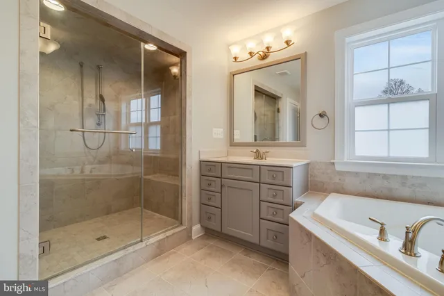 an empty room with ceiling fan and window