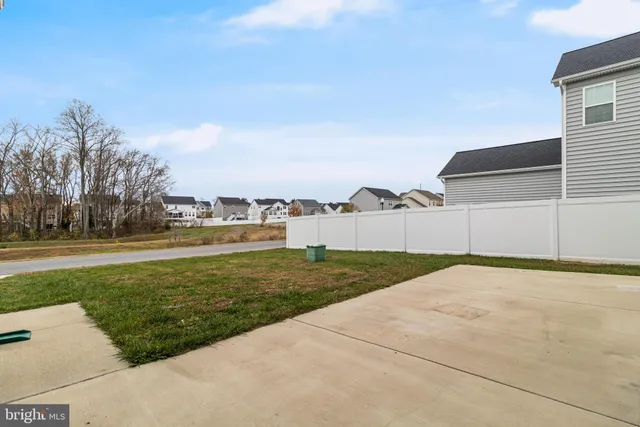 a view of a house with backyard and deck