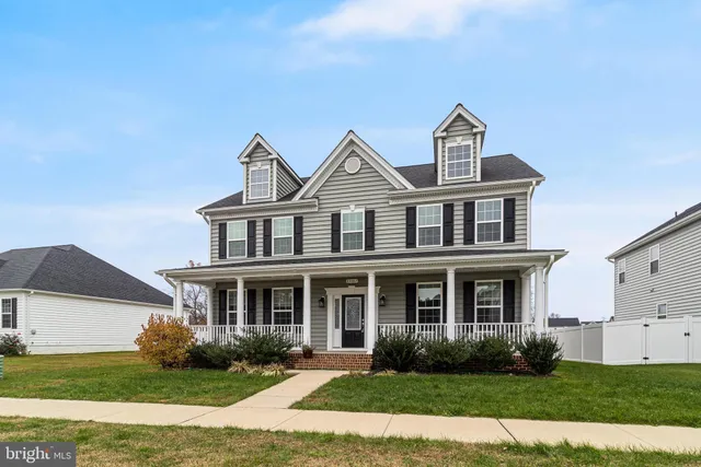 a front view of a house with garden and porch