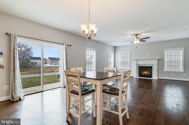 a view of a livingroom with furniture wooden floor clock and a chandelier