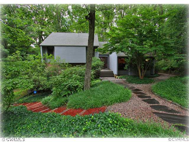 a aerial view of a house with yard and green space
