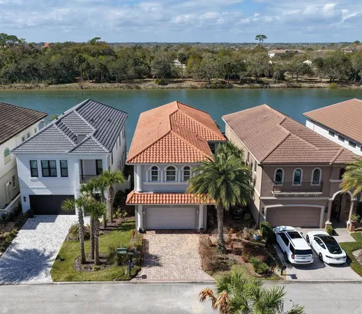 an aerial view of a house with outdoor space and lake view