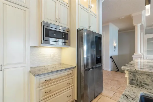 an aerial view of a house with a yard and lake view