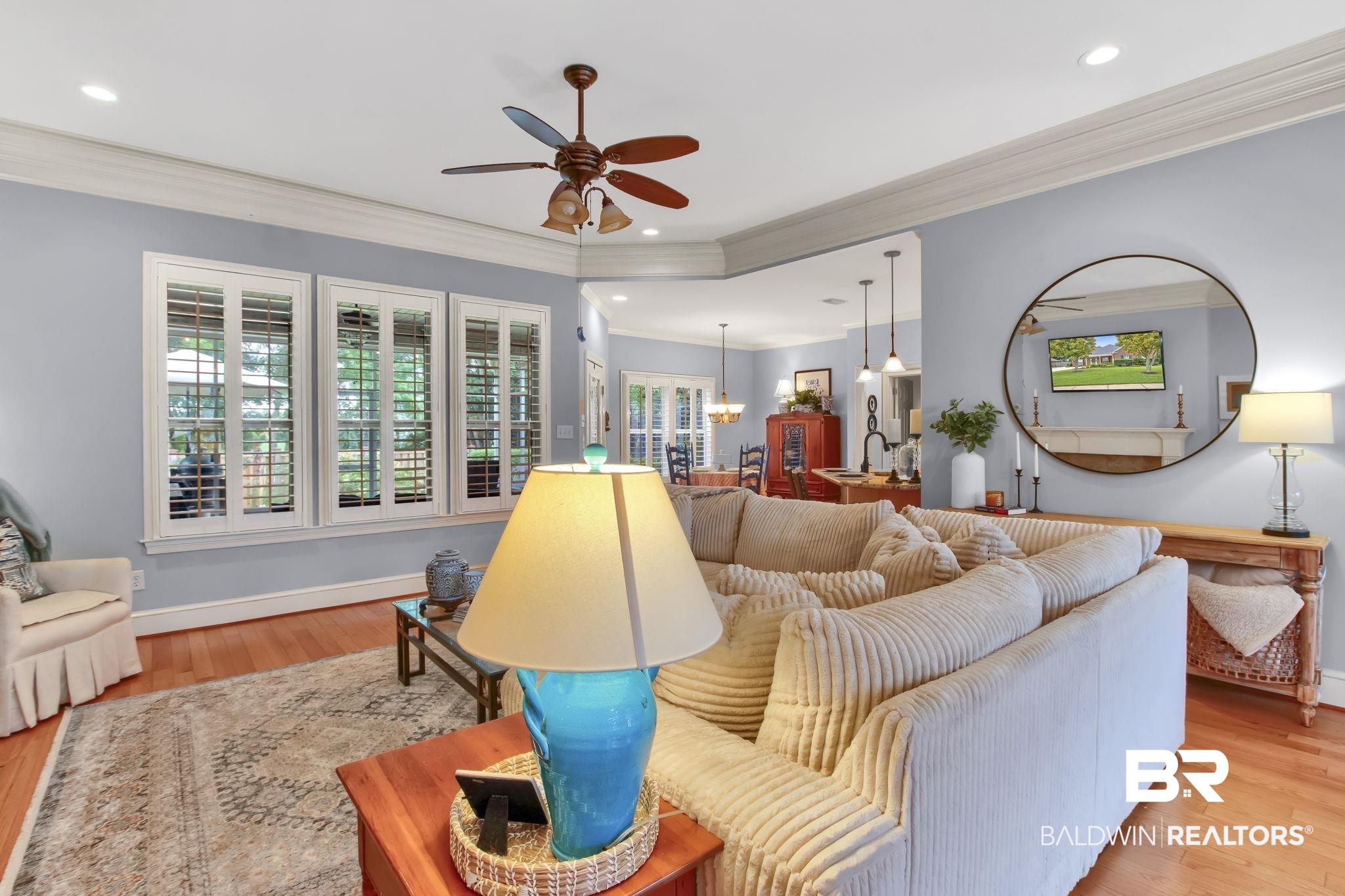 9478 Autauga Bend Daphne, AL 36526 - Photo 44 of 73 Living room featuring ceiling fan with notable chandelier, crown molding, and light hardwood / wood-style floors