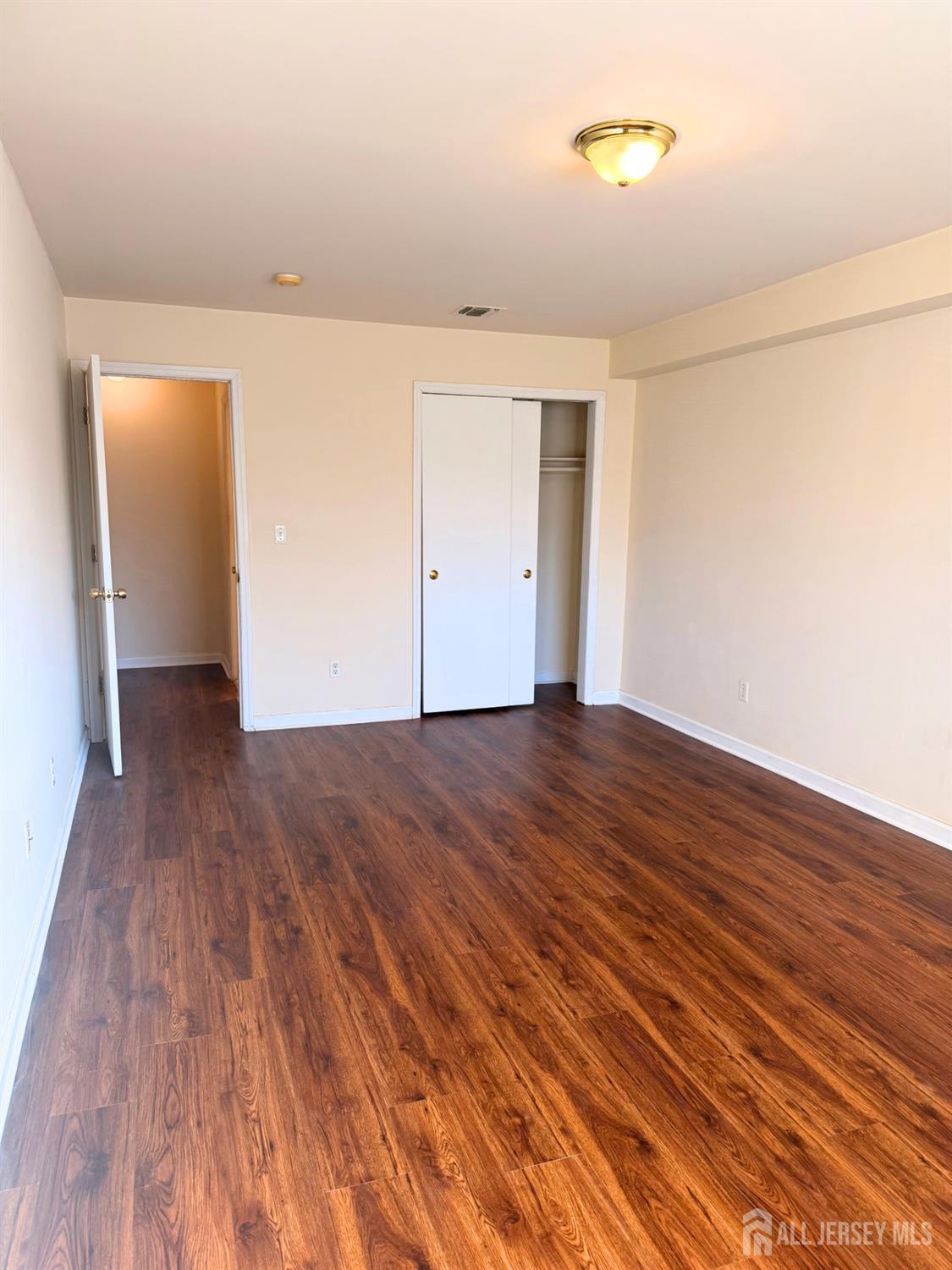 413 College Drive Edison, NJ 08817 - Photo 18 of 20 a view of an empty room with wooden floor