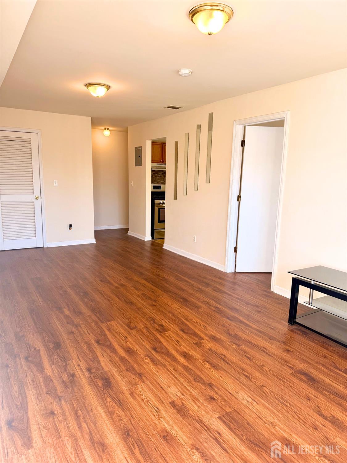 413 College Drive Edison, NJ 08817 - Photo 6 of 20 a view of an empty room with wooden floor