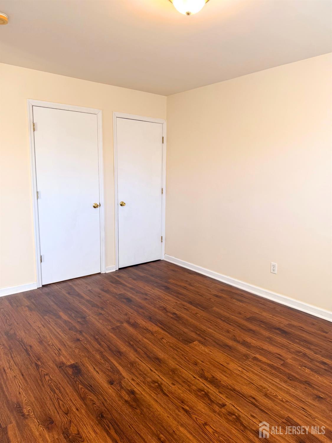 413 College Drive Edison, NJ 08817 - Photo 9 of 20 a view of empty room with wooden floor
