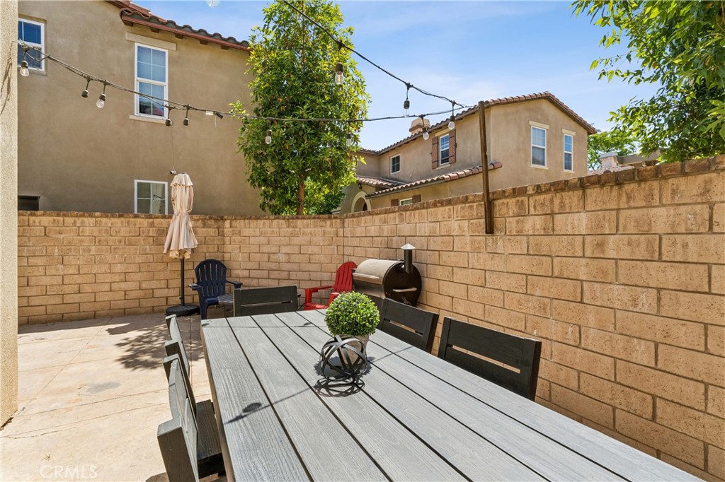4155 Windspring Street Corona, CA 92883 - Photo 31 of 38 a view of a patio with wooden floor and a yard