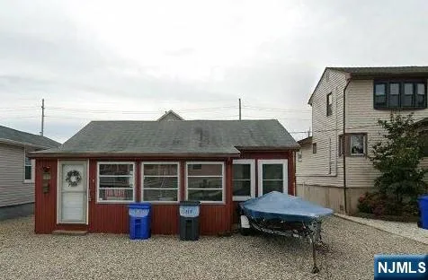a front view of a house with outdoor seating