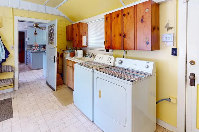 a utility room with a sink a washer and dryer