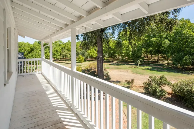 a view of balcony with wooden floor