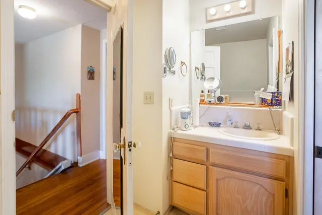 a en suite bathroom with a sink a mirror and a shower
