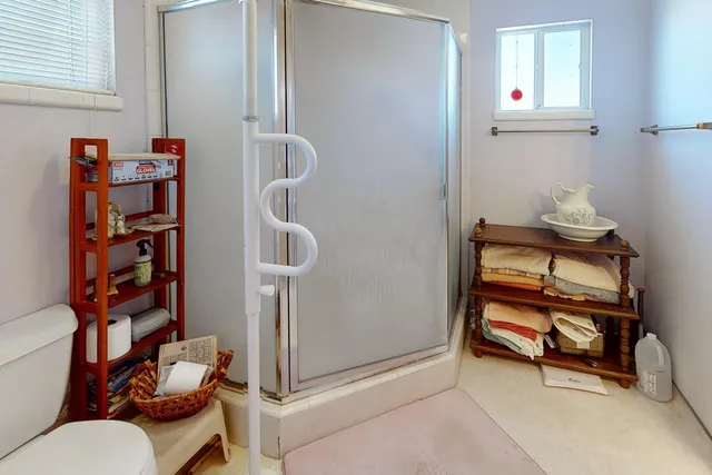 a bathroom with a toilet and a shower curtain