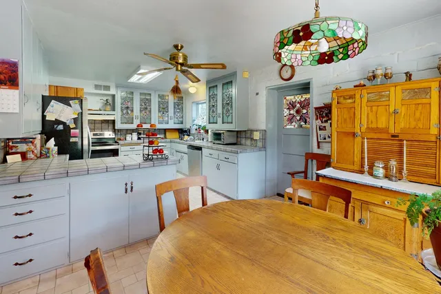 a kitchen with stainless steel appliances kitchen island granite countertop a sink and cabinets